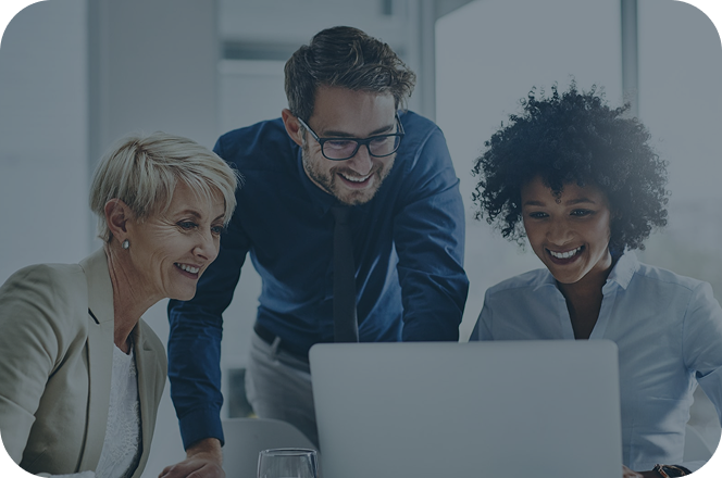 Three people looking at a laptop